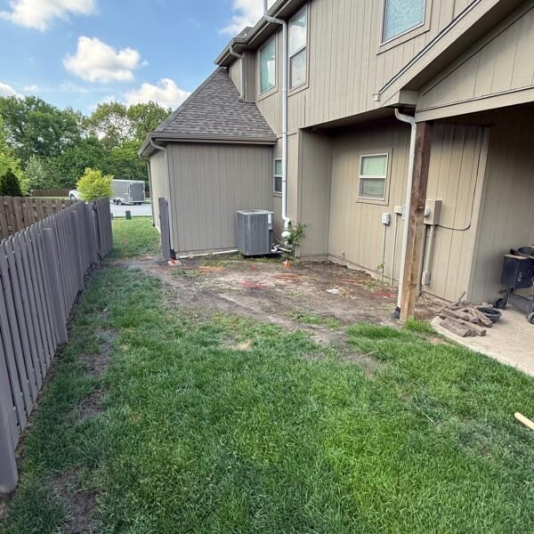 Yard before drainage and rock landscaping project